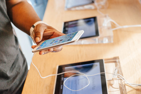 PARIS, FRANCE - SEPTEMBER 20, 2014: Man trying the new iPhone 6 Plus at the Apple Inc. store in...