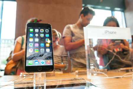 PARIS, FRANCE - SEPTEMBER 20, 2014: An iPhone 6 smartphone stands on display inside an Apple Store...