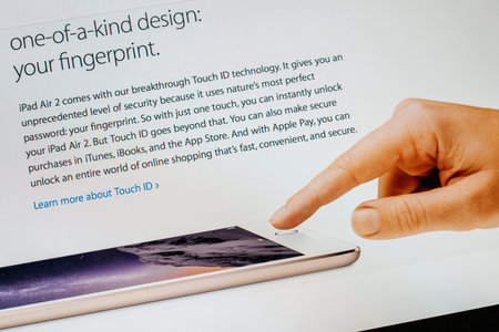 PARIS, FRANCE - 17 OCTOBER 2014: Photo of Apple iPad tablet with apple.com webpage of the new iPad Air 2 and iPad Mini 3 featuring fingerprint security button. Apple unveiled the new iMac iPad Air 2 and iPad Mini 3 on 16 Octのeditorial素材