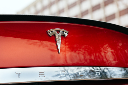 PARIS, FRANCE - NOVEMBER 29: Tesla Model S signage of a red car at Paris showroom, France. Tesla is an American company that designs, manufactures, and sells electric carsのeditorial素材
