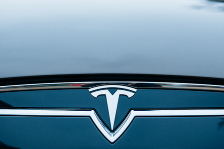 PARIS, FRANCE - NOVEMBER 29:  The Tesla Motors Inc. badge and logo are seen below the hood of the Model S electric vehicle displayed at the company's showroom in Paris, Franceのeditorial素材