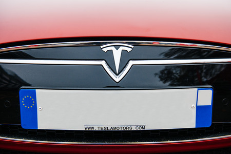 PARIS, FRANCE - NOVEMBER 29:  The Tesla Motors Inc. badge logo and plate empty numbers are seen below the hood of the Model S electric vehicle displayed at the companyのeditorial素材