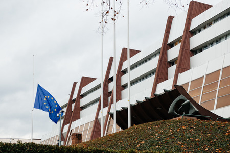 The European Union Flag flies at half-mast in front of the Counci of Europe on January 8, 2015 following an attack the day before against French satirical weekly newspaper Charlie Hebdo offices in Paris which left 12 people deadのeditorial素材