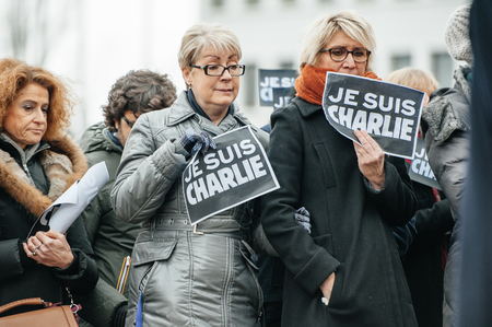 STRASBOURG, FRANCE - JANUARY 09, 2015: Council of Europe employees holding JE SUIS CHARLIE poster during a silent vigil to condemn the gun attack at French satirical magazine Charlie Hebdo office in Paris, which killed 12 people on January 7, 2015のeditorial素材