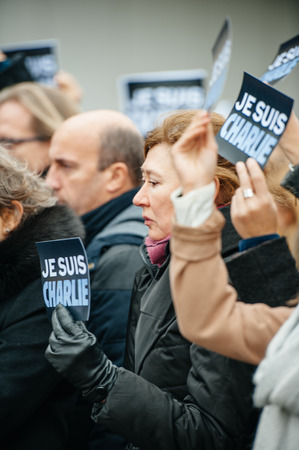 STRASBOURG, FRANCE - JANUARY 09, 2015: Council of Europe employees holding JE SUIS CHARLIE poster during a silent vigil to condemn the gun attack at French satirical magazine Charlie Hebdo office in Paris, which killed 12 people on January 7, 2015のeditorial素材