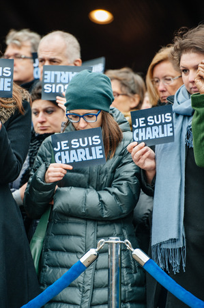STRASBOURG, FRANCE - JANUARY 09, 2015: Council of Europe employees holding JE SUIS CHARLIE poster during a silent vigil to condemn the gun attack at French satirical magazine Charlie Hebdo office in Paris, which killed 12 people on January 7, 2015のeditorial素材