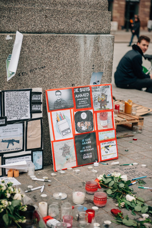 STRASBOURG, FRANCE - 10 JAN, 2015: Light candles and pencils near General Kleber statue in tribute to the victims of the terrorist attacks in Paris on January 11, 2015のeditorial素材