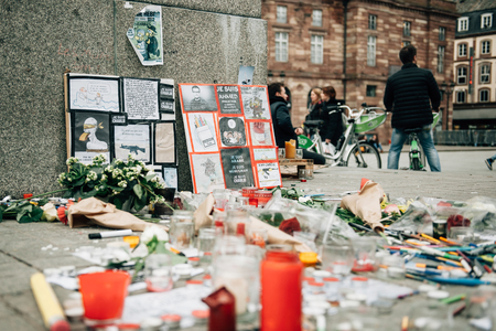 STRASBOURG, FRANCE - 10 JAN, 2015: Light candles and pencils near General Kleber statue in tribute to the victims of the terrorist attacks in Paris on January 11, 2015のeditorial素材
