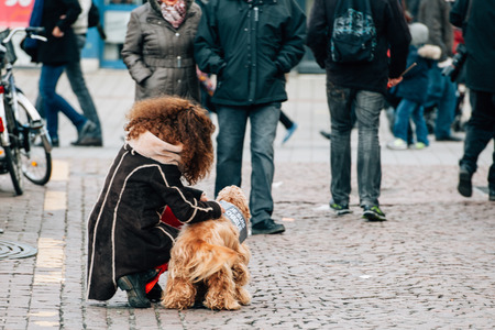 STRASBOURG, FRANCE - 11 JAN, 2015:  Girl attaching to her dog plancard 'Je suis Charlie' during a unity rally (Marche Republicaine) where some 50000 people took part in tribute three-day killing spree in Parisのeditorial素材