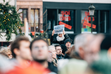 STRASBOURG, FRANCE - 11 JAN, 2015:  People hold placards reading 'Charlie iss alive!' during a unity rally (Marche Republicaine) where some 50000 people took part in tribute three-day killing spree in Parisのeditorial素材