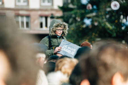 STRASBOURG, FRANCE - 11 JAN, 2015:  Kid holding placard reading 'Je suis Charlie' during a unity rally (Marche Republicaine) where some 50000 people took part in tribute three-day killing spree in Parisのeditorial素材