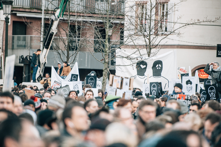 STRASBOURG, FRANCE - 11 JAN, 2015:  People hold placards reading 'Je suis Charlie' during a unity rally (Marche Republicaine) where some 50000 people took part in tribute three-day killing spree in Parisのeditorial素材