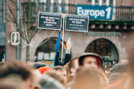 STRASBOURG, FRANCE - 11 JAN, 2015:  People hold placards reading 'We can laugh at everything" during a unity rally (Marche Republicaine) where some 50000 people took part in tribute three-day killing spree in Parisのeditorial素材