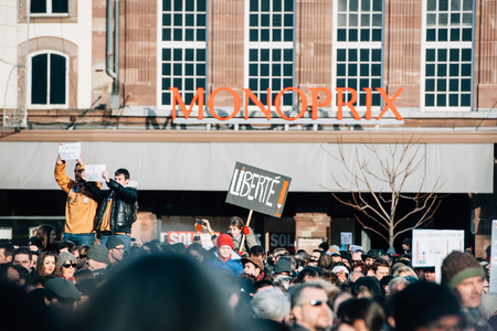 STRASBOURG, FRANCE - 11 JAN, 2015:  People hold placards reading 'Freedom' during a unity rally (Marche Republicaine) where some 50000 people took part in tribute three-day killing spree in Parisのeditorial素材