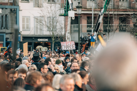 STRASBOURG, FRANCE - 11 JAN, 2015:  People hold placards reading 'Je suis Charlie' during a unity rally (Marche Republicaine) where some 50000 people took part in tribute three-day killing spree in Parisのeditorial素材