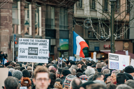 STRASBOURG, FRANCE - 11 JAN, 2015:  People hold placards reading 'Je suis Charlie' during a unity rally (Marche Republicaine) where some 50000 people took part in tribute three-day killing spree in Parisのeditorial素材