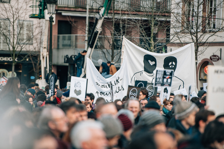 STRASBOURG, FRANCE - 11 JAN, 2015:  People hold placards reading 'Je suis Charlie' during a unity rally (Marche Republicaine) where some 50000 people took part in tribute three-day killing spree in Parisのeditorial素材