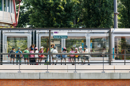 STRASBOURG, FRANCE - JUNE 29: Group of kids waiting tram at Human Rights Station (Droit de l\Homme) in front of European Court of human Rights in Strasbourg, France, on June 29, 2010のeditorial素材