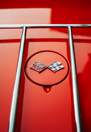FRANCE, PARIS - FEB 10, 2013: Trunk ornament of racing flags on a 1962 Corvette automobile. The Chevrolet Corvette is a sports car manufactured by the Chevrolet division of American automotive General Motors (GM)のeditorial素材