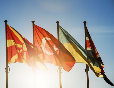 Macedonia Flag, Turkey Flag, Ukraine Flag and United Kingdom Flag on a blue clear sky in Strasbourg, France - in front of the Council of Europeの写真素材