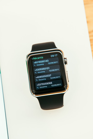 PARIS, FRANCE â APR 10, 2015: New wearable computer Apple Watch smartwatch displaying the new Calling App. Apple Watch incorporates fitness tracking and health-oriented capabilities and  integration with iOS Apple products and servicesのeditorial素材