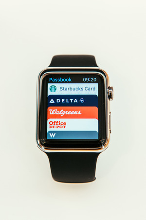 PARIS, FRANCE â APR 10, 2015: New wearable computer Apple Watch smartwatch displaying the new Passbook App. Apple Watch incorporates fitness tracking and health-oriented capabilities and  integration with iOS Apple products and servicesのeditorial素材
