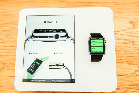 PARIS, FRANCE â APR 10, 2015: New wearable computer Apple Watch smartwatch displaying the new Sport Edition. Apple Watch incorporates fitness tracking and health-oriented capabilities and  integration with iOS Apple products and servicesのeditorial素材