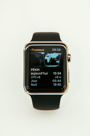 PARIS, FRANCE â APR 10, 2015: New wearable computer Apple Watch smartwatch displaying the new Time Zone App. Apple Watch incorporates fitness tracking and health-oriented capabilities and  integration with iOS Apple products and servicesのeditorial素材