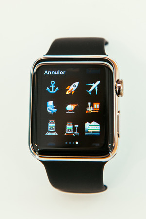 PARIS, FRANCE â APR 10, 2015: New wearable computer Apple Watch smartwatch displaying the new travel emoji. Apple Watch incorporates fitness tracking and health-oriented capabilities and  integration with iOS Apple products and servicesのeditorial素材