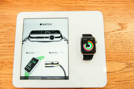 PARIS, FRANCE â APR 10, 2015: New wearable computer Apple Watch smartwatch displaying the new Sport Edition. Apple Watch incorporates fitness tracking and health-oriented capabilities and  integration with iOS Apple products and servicesのeditorial素材