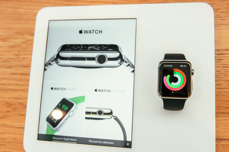 PARIS, FRANCE â APR 10, 2015: New wearable computer Apple Watch smartwatch displaying the new Sport Edition. Apple Watch incorporates fitness tracking and health-oriented capabilities and  integration with iOS Apple products and servicesのeditorial素材