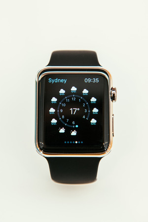 PARIS, FRANCE â APR 10, 2015: New wearable computer Apple Watch smartwatch displaying the new Weather App. Apple Watch incorporates fitness tracking and health-oriented capabilities and  integration with iOS Apple products and servicesのeditorial素材