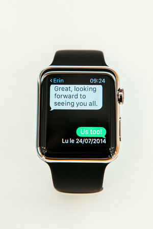 PARIS, FRANCE â APR 10, 2015: New wearable computer Apple Watch smartwatch displaying the new Message App . Apple Watch incorporates fitness tracking and health-oriented capabilities and  integration with iOS Apple products and servicesのeditorial素材