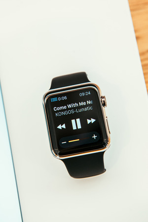 PARIS, FRANCE â APR 10, 2015: New wearable computer Apple Watch smartwatch displaying the new Remmote App and iTunes Library control. Apple Watch incorporates fitness tracking and health-oriented capabilities and  integration with iOS Apple products andのeditorial素材