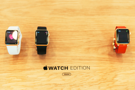 PARIS, FRANCE â APR 10, 2015: New wearable computer Apple Watch smartwatch displaying the Edition gold collection. Apple Watch incorporates fitness tracking and health-oriented capabilities and  integration with iOS Apple products and servicesのeditorial素材