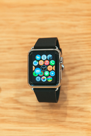PARIS, FRANCE â APR 10, 2014: New wearable computer Apple Watch smartwatch displaying the new interface home screen. It incorporates fitness tracking and health-oriented capabilities and  integration with iOS Apple products and servicesのeditorial素材