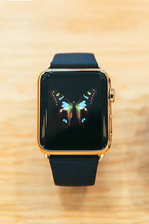 PARIS, FRANCE â APR 10, 2015: New wearable computer Apple Watch smartwatch displaying the Edition gold collection. Apple Watch incorporates fitness tracking and health-oriented capabilities and  integration with iOS Apple products and servicesのeditorial素材