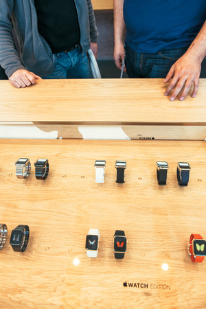 PARIS, FRANCE â APR 10, 2015: New wearable computer Apple Watch smartwatch displaying the Watch collection. Apple Watch incorporates fitness tracking and health-oriented capabilities and  integration with iOS Apple products and servicesのeditorial素材