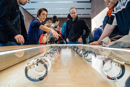 PARIS, FRANCE - APR 10, 2015: Apple genius presenting the Apple Watch smartwatchesfor customers and clients at Apple Store. The most wanted wearable device will be on sale from April 24 in 9 countries and regionsのeditorial素材