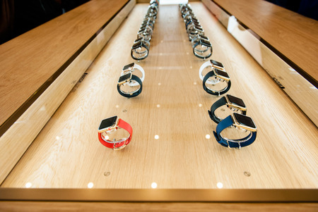 PARIS, FRANCE â APR 10, 2015: Apple Watch smartwatches in a row under procted glass are displayed at an Apple Store. The most wanted wearable device will be on sale from April 24 in 9 countries and regionsのeditorial素材