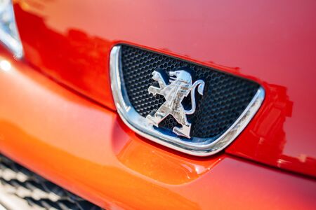 PARIS, FRANCE - APRIL 18, 2014: Peugeot lion logo on a red sport car. Peugeot is a French car brand, part of PSA Peugeot Citroen. In 2013, Peugeot ranked at the second lowest average CO2 emissions among generalist brands in Europe, with 114.9g CO2/kmのeditorial素材