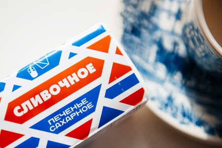 MOSCOW, RUSSIA - SEP 11, 2014: Traditional russian biscuit Slivochnoye Pechen'ye next to a tea cup.のeditorial素材