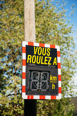 Vous Roulez A - Your Speed vehicle speed detector sign showing current car speed that just passed senn in French cityの写真素材