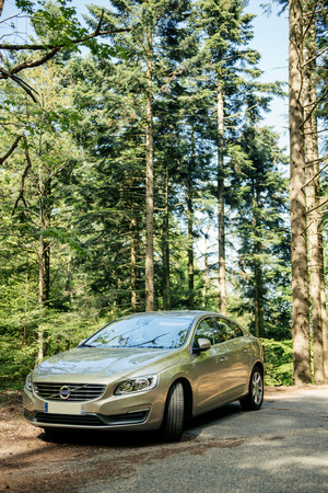 FRANCE  MAY 10 2015: Hybrid Volvo S60 executive car parked in the middle of green forest. Volvo Hybrid Electric Vehicle is considered one of the most safe and environmentally protective automobileのeditorial素材