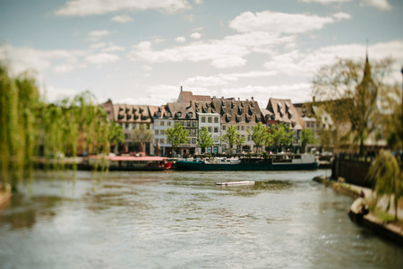 STRASBOURG FRANCE  APRIL 18 2015: Quai des Pecheurs Fishermen Quay with barges on Ill river and waterfront houses seen through a tiltshift lensのeditorial素材