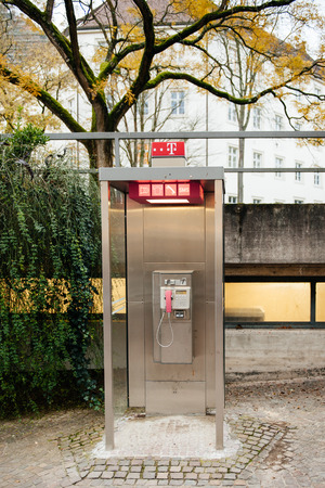 BADENBADEN GERMANY  MOVEMBER 20 214: Deutsche Telekom AG payphone booth at duskのeditorial素材