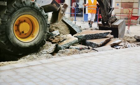 Tractor truck tire on a broken asphalt at construction site in urban environmentの写真素材