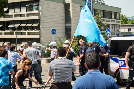 STRASBOURG, FRANCE - JULY 11, 2015: Police use pepper spray to prevent clash - Uyghur human rights activists participate in a demonstration to protest against Chinese government's policy in Uyghurのeditorial素材