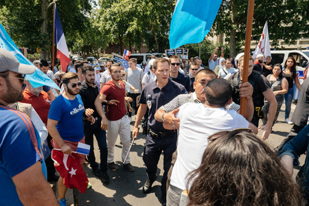 STRASBOURG, FRANCE - JULY 11, 2015: Police use force to prevent clash while Uyghur human rights activists participate in a demonstration to protest against Chinese government's policy in Uyghurのeditorial素材