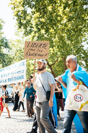 STRASBOURG, FRANCE - JULY 11, 2015: Uyghur human rights activists participate in a demonstration to protest against Chinese government's policy in Uyghurのeditorial素材